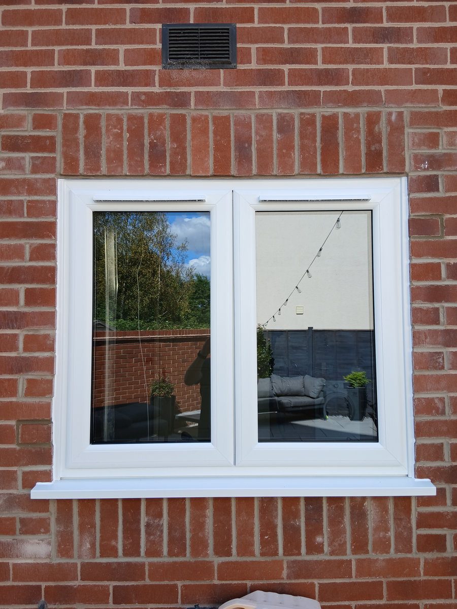 White uPVC casement window in brick