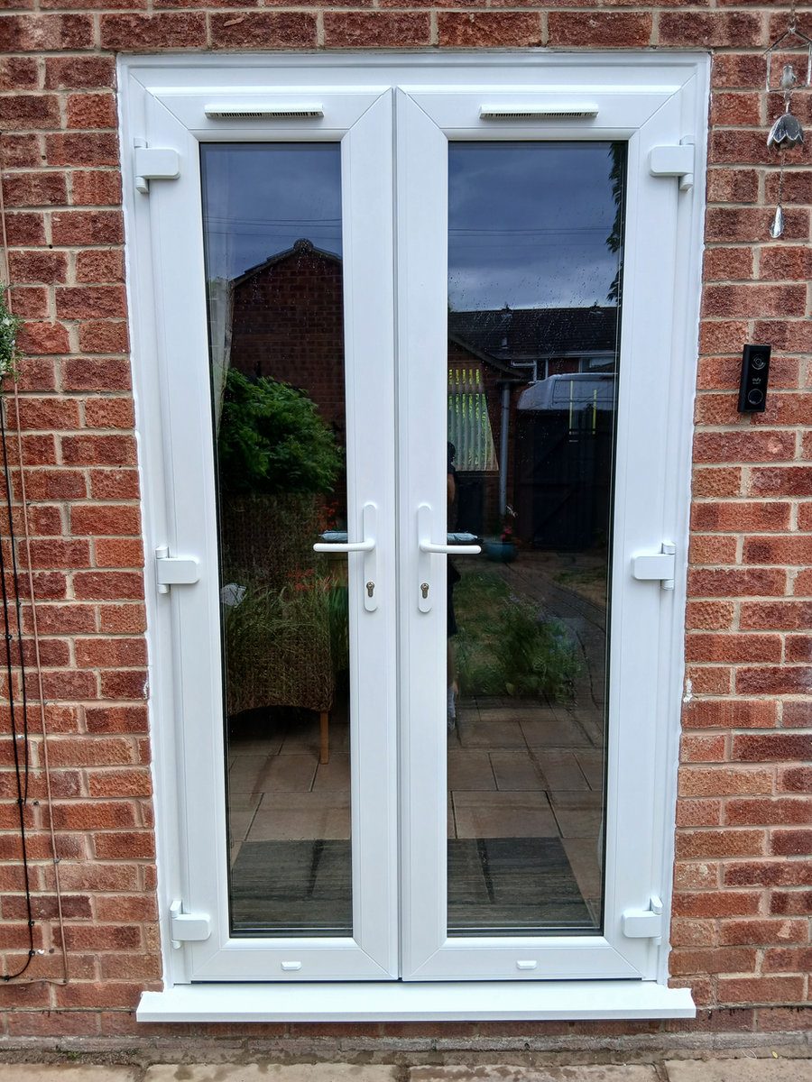 White uPVC French doors opening to a patio